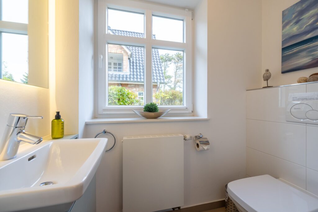 Badezimmer mit kleiner Heizung in Ferienwohnung auf Sylt